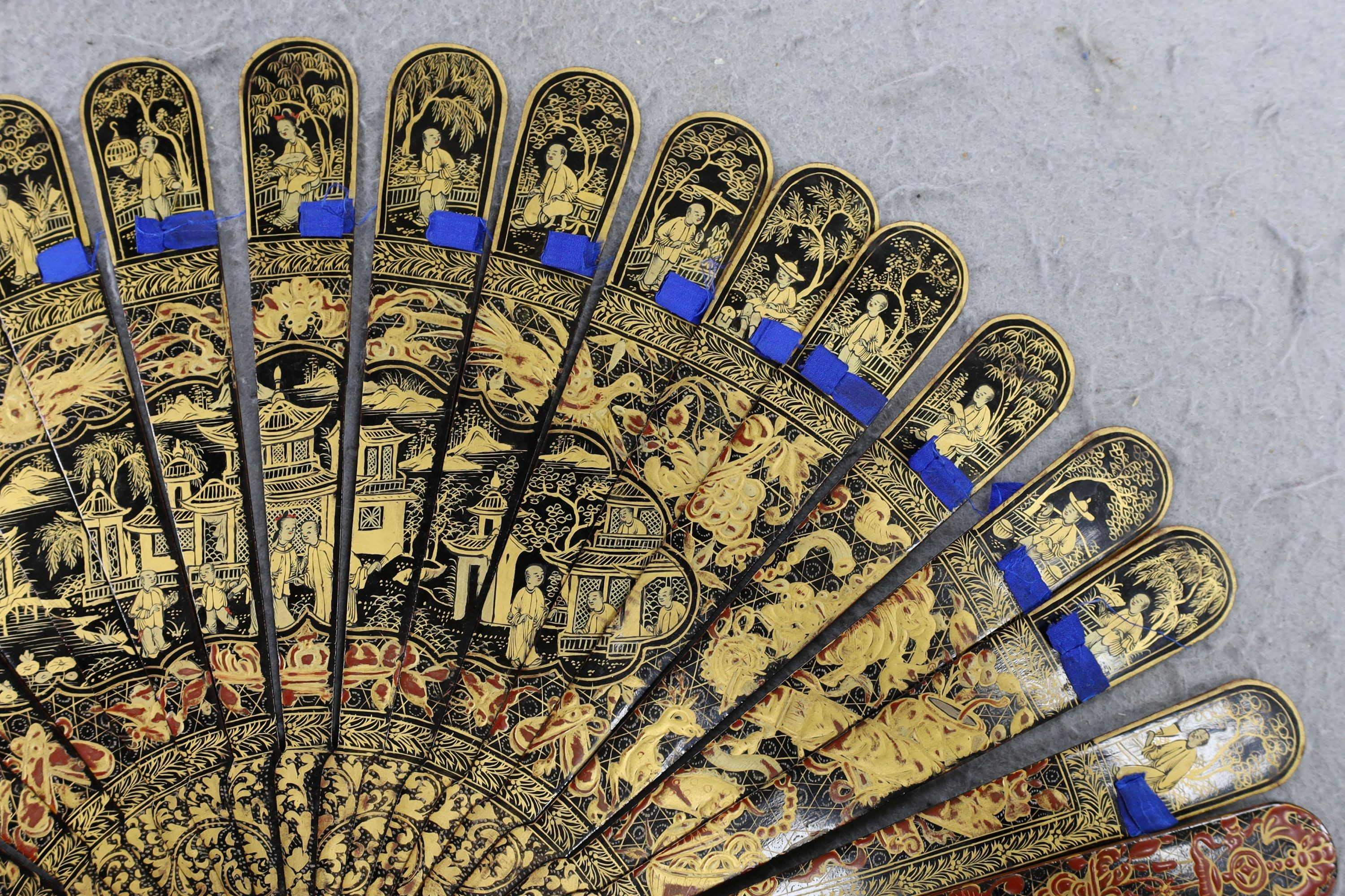 A Chinese gilt-decorated lacquer fan in a brocade covered case, 19th century